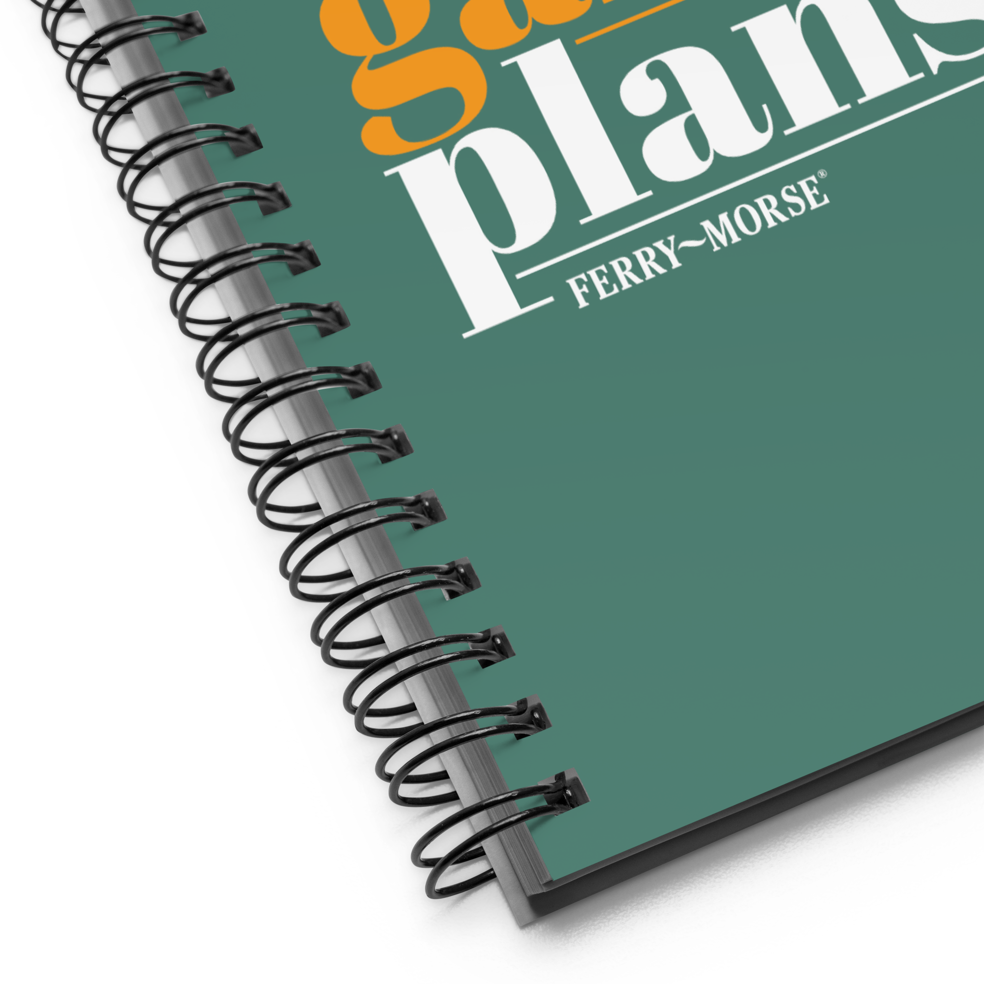 A green spiral-bound notebook with the title 'my big garden plans' printed on the cover, alongside an illustration of a carrot.